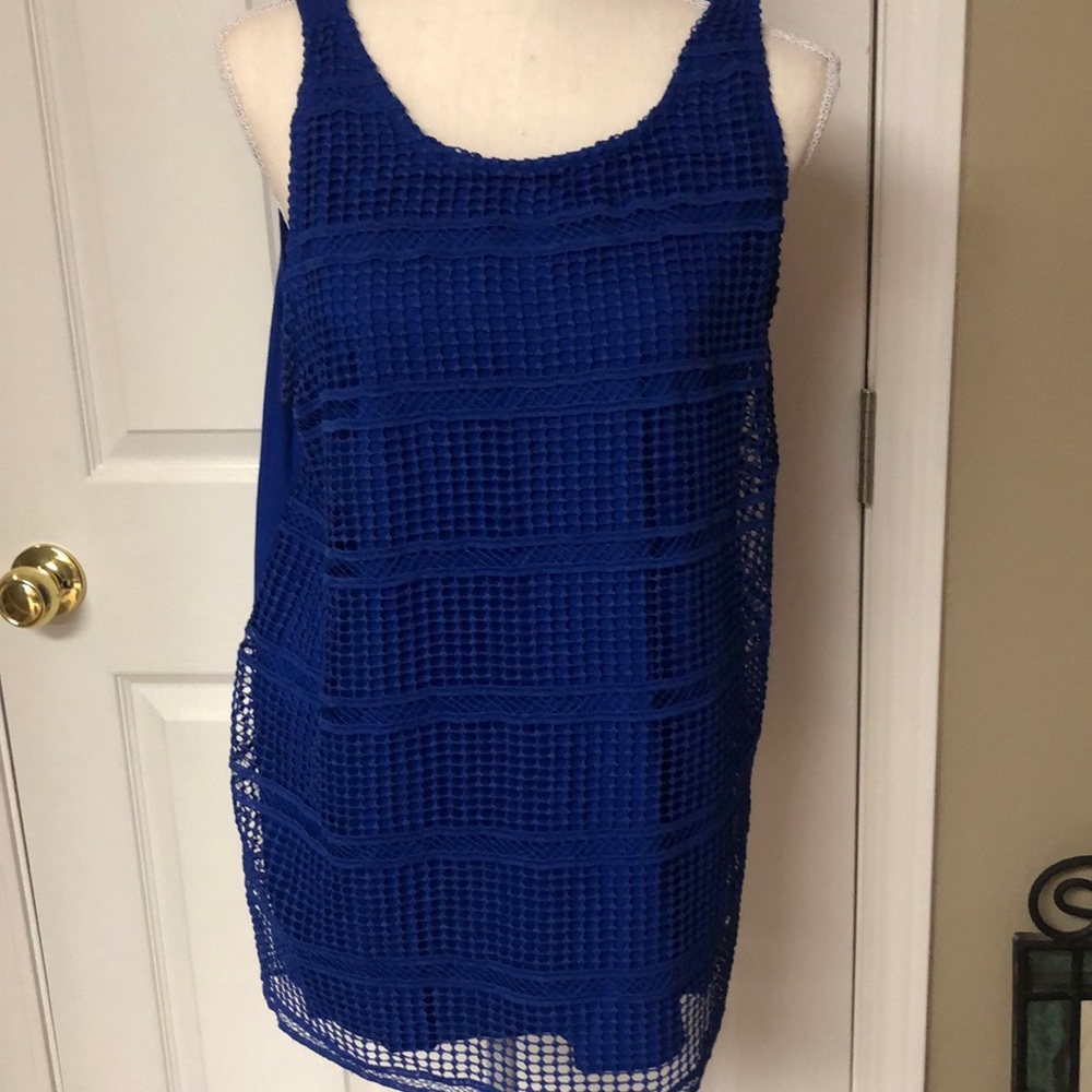 Bright blue tank w/lace overlay in front.